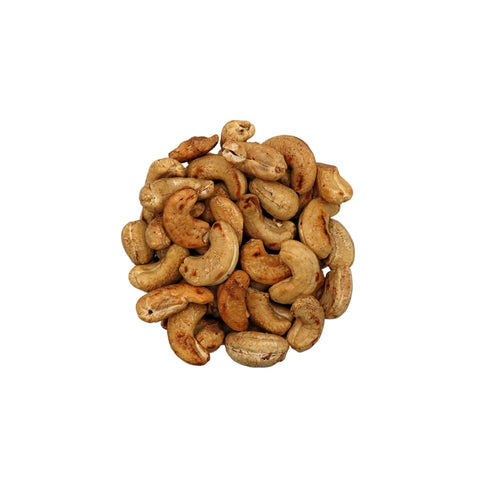 Unsalted cashews in a clear glass bowl, photographed from directly above on a clean white background.