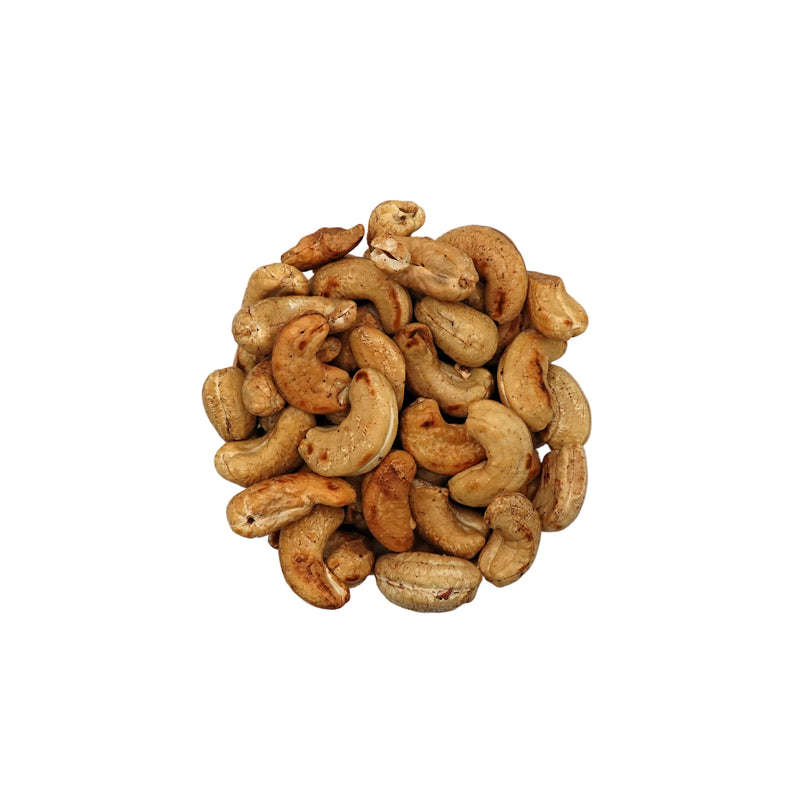 Unsalted cashews in a clear glass bowl, photographed from directly above on a clean white background.