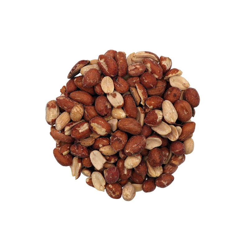 A clear glass bowl filled with roasted and salted spanish peanuts, photographed on a plain white studio background.