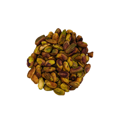 A clear glass bowl filled with unsalted pistachios, photographed from above on a plain white background.
