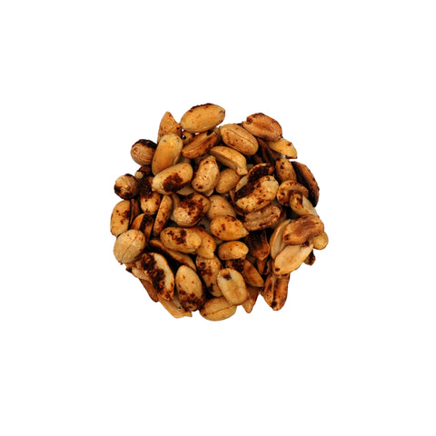 Roasted chili lime peanuts in a clear glass bowl, photographed from a top-down view on a plain white background.