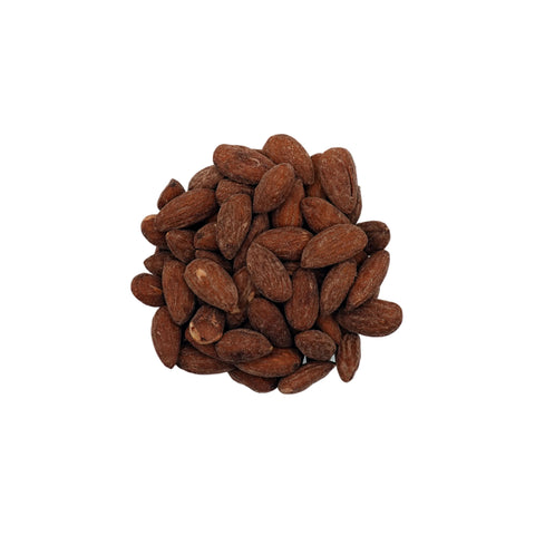 Salted almonds piled in a small clear glass bowl on a clean white background.